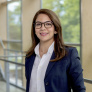 Portrait of Dr. Safa Omri in front of a stair railing