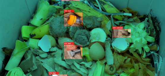 IDS industrial cameras detect plastic waste as foreign matter between organic waste in an open container.