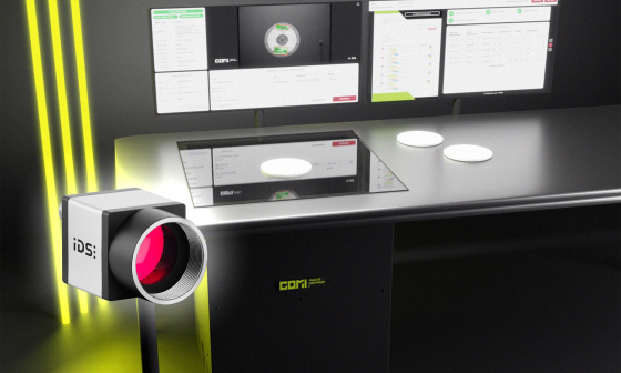 COMI Label Reader as a desktop scanner, with three yellow light bars on the left and an uEye camera in front