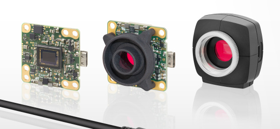 3 uEye LE camera with lenses and protective frame pointing to the right, with a cable in front of it