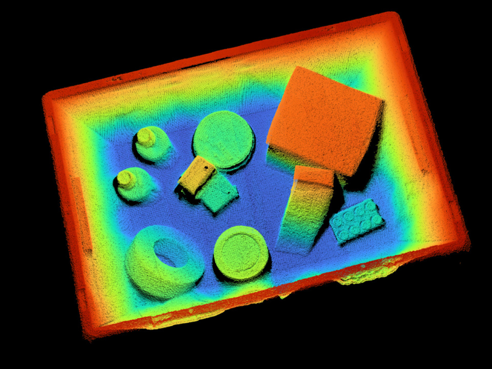 A colorful 3D point cloud of various objects in a box