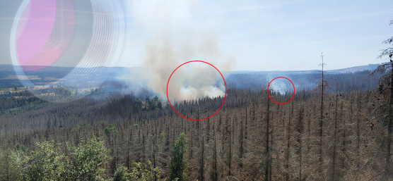 Forest fire marked in red, with an IDS industrial camera faded in the top left corner