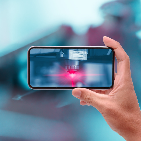 Hand raises cell phone horizontally, red light illuminates on cell phone