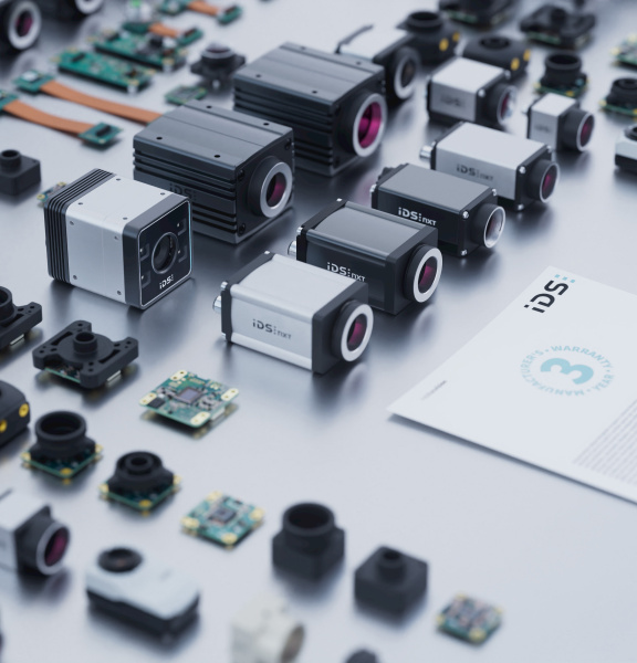 IDS industrial cameras on a table with a 3-year warranty document