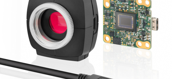 Image of a uEye camera, left with housing, right without, cable in front
