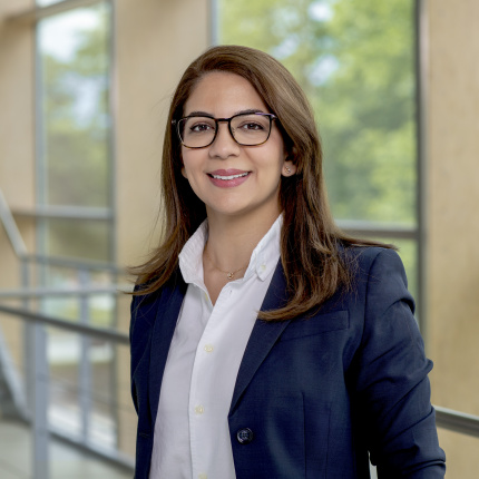 Portrait of Dr. Safa Omri in front of a stair railing