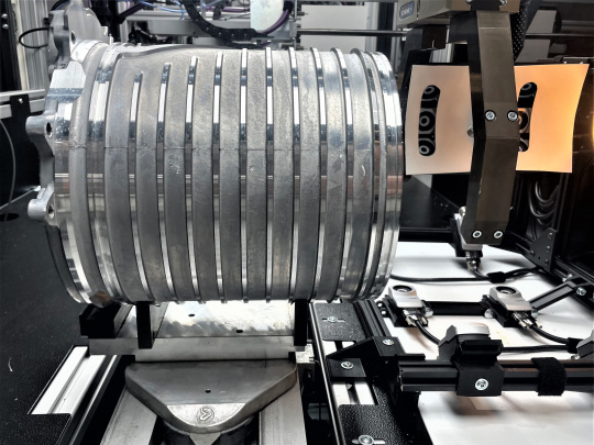Round aluminum component of an electric motor inside a test cell