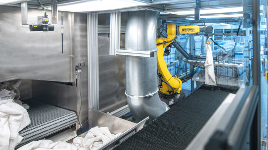 Robot with 3D camera system folds towels in industrial laundry