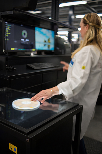 A woman scans a round label using the Vision AI Label Reader.