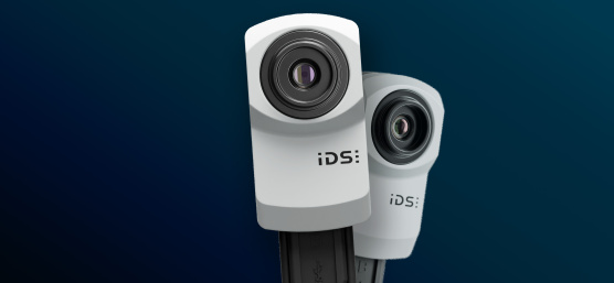 Two IDS uEye SC industrial cameras on blue background.