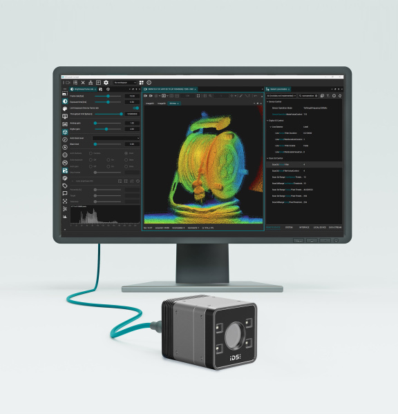 3D camera in front of a monitor displaying a colored point cloud and a software interface