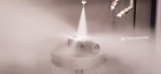 Industrial camera is exposed to powerful water jets from all sides in spray system