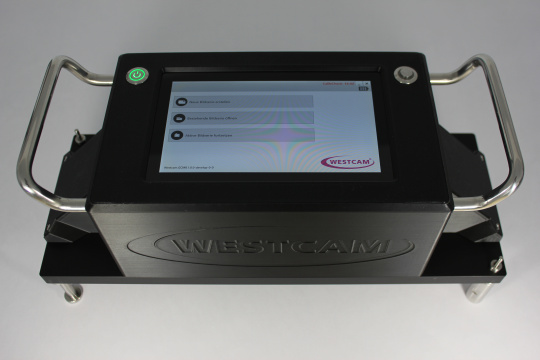 WESTCAM device with touchscreen, green power button, and metal handles