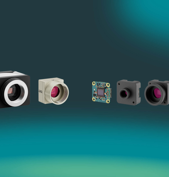 Row of IDS industrial cameras on a blue gradient background