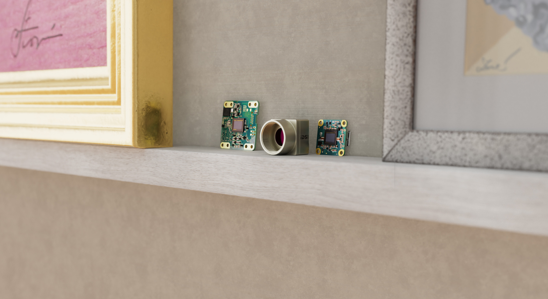 USB3 uEye XCP, XLS and GigE uEye LE cameras are positioned on a picture rail between 2 classic picture frames