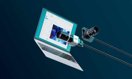 Two monitoring cameras in front of an open laptop