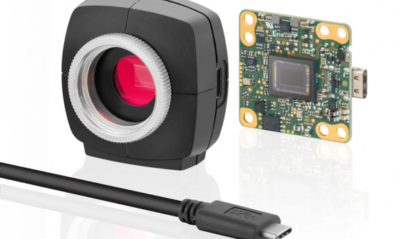 Image of a uEye camera, left with housing, right without, cable in front