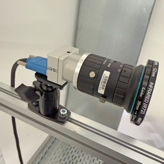 IDS industrial camera with a large lens and NIR filter mounted on an aluminium profile