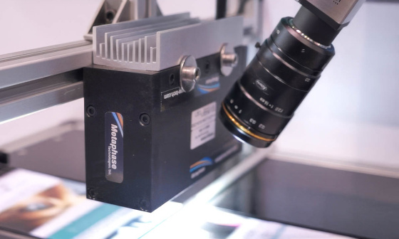 IDS uEye camera with lens observes a production of printed paper