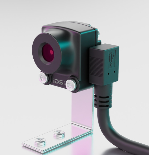 Black uEye XS camera on a silver tripod, connected to the side with a cable.