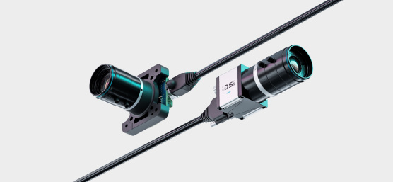 Two IDS uEye live monitoring cameras with cable are arranged diagonally.