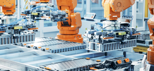 Robotic arms move objects in a machine.