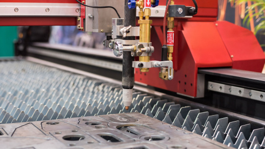 Laser cutting machine processing metal parts on an automated line