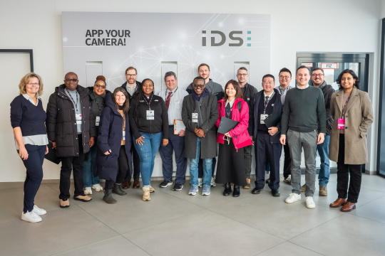 MIT REAP program visitor group during their stay at IDS in front of a brand wall