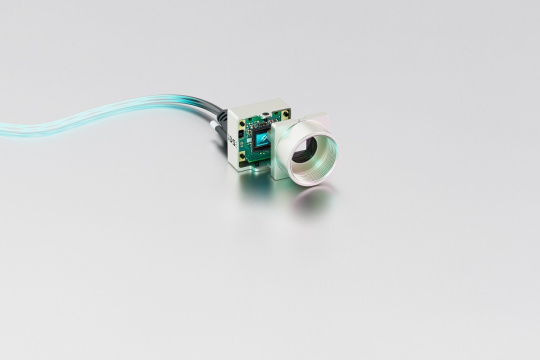 uEye XCP camera with cable in front of a gray background.
