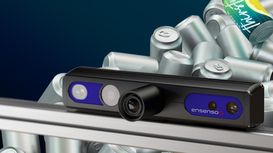 An Ensenso 3D camera is positioned in front of a pile of silver cans. One can is colored and labeled.