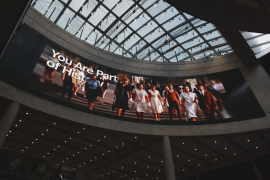 Oversized projection of a historical scene beneath the glass dome at the Haus der Geschichte