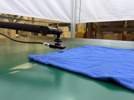 uEye XC camera—placed above a blue T-shirt—takes a close-up shot.