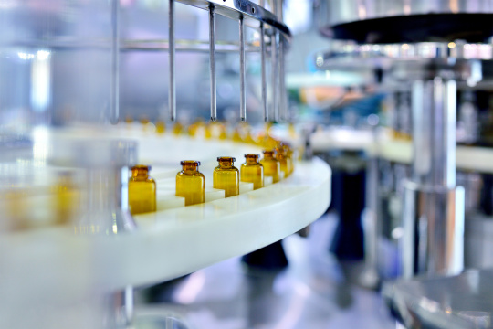 Medicine vials pass through a machine