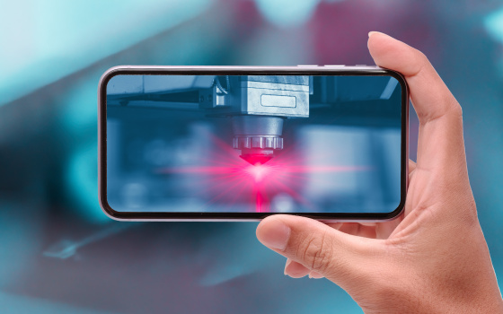 Hand raises cell phone horizontally, red light illuminates on cell phone