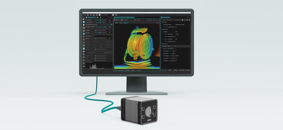 3D camera in front of a monitor displaying a colored point cloud and a software interface