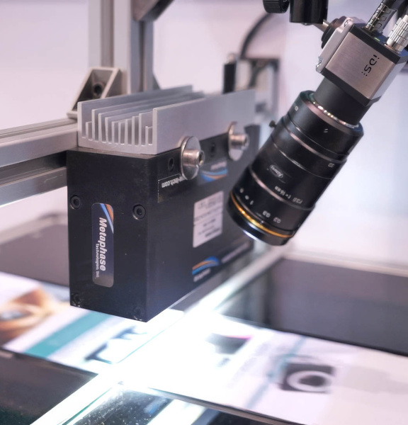 IDS uEye camera with lens observes a production of printed paper