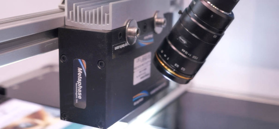 IDS uEye camera with lens observes a production of printed paper